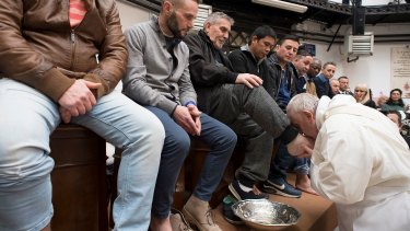 Pope Francis washes the feet of inmates during his visit to the Regina Coeli detention centre in March.