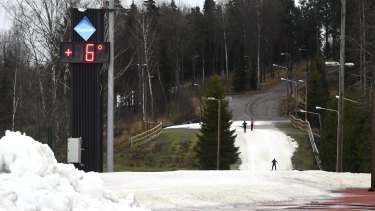 People ski on artificial snow, used instead of real snow because of unseasonably warm weather, in Vantaa, Finland, on January 7. 