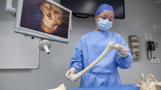  Associate Professor Jodie Ward examining skeletal remains at the AFP forensic facility in Canberra.