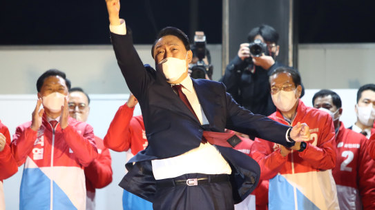 Newly elected president Yoon Suk-yeol celebrates with supporters in Seoul.