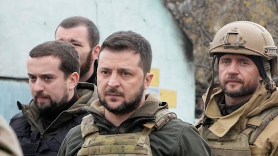 Ukrainian President Volodymyr Zelensky examines the site of a recent battle in Bucha.
