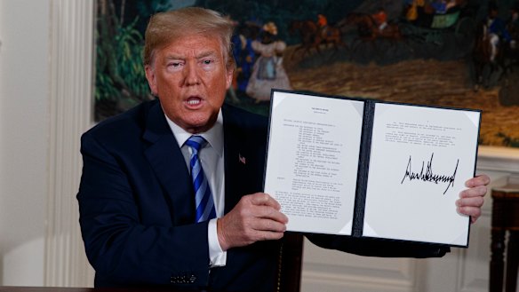 US President Donald Trump shows a signed memorandum to pull out of the Iran nuclear deal.