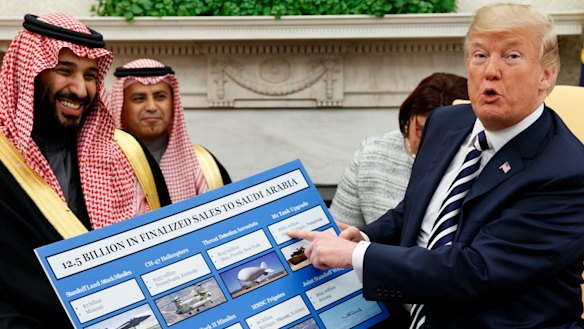 US President Donald Trump holds a chart highlighting arms sales to Saudi Arabia during a meeting with Saudi Crown Prince Mohammed bin Salman in the Oval Office in March.