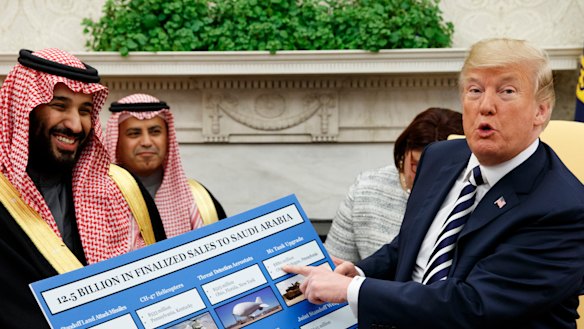 US President Donald Trump holds a chart highlighting arms sales to Saudi Arabia during a meeting with Saudi Crown Prince Mohammed bin Salman in the Oval Office in March.