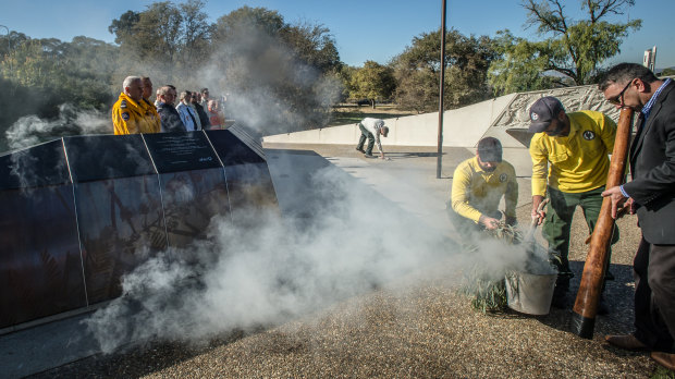 A smoking ceremony is held as the new memorial wall is unveiled on Tuesday.
