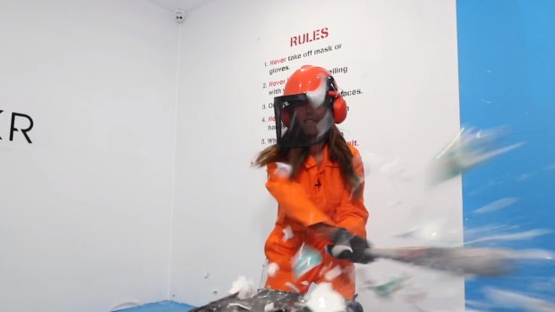 Journalist Serena Coady smashes up some crockery at Breakr, Canberra's destruction room.