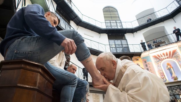 Pope Francis washes the feet of an inmate at the Regina Coeli detention centre in Rome.