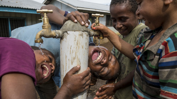 Children enjoying water from a tap in the village of Humbra, Southern Highlands. The restoration of water and sanitation infrastructure was one of the priorities of the UN in the aftermath of the earthquake.