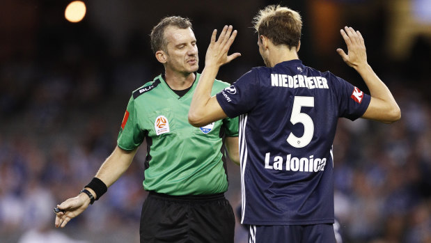 The referee prepares to show Georg Niedermeier a red card.