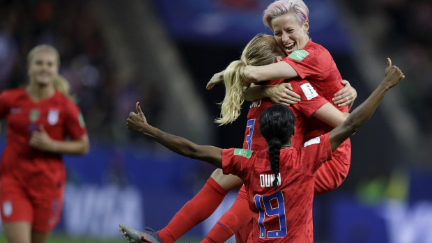 United States' scorer Samantha Mewis lifts her teammate Megan Rapinoe as she celebrates her side's fourth goal.