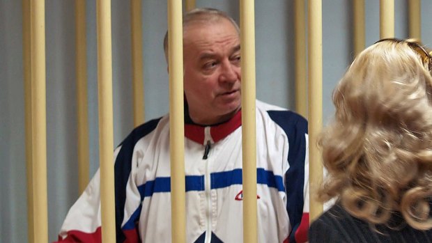A photo dated August 9, 2006, shows Sergei Skripal talking from a defendants' cage to his lawyer during a hearing at the Moscow District Military Court.