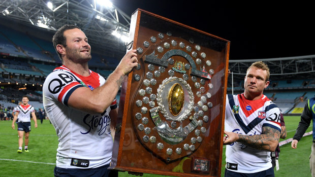 Finishing on top: Boyd Cordner and Jake Friend hold the J.J. Giltinan Shield after claiming the minor premiership.