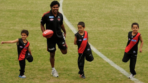 Essendon’s Alwyn Davey exercises with his children Alijah, Jayden, and Alwyn Jnr back in 2012.