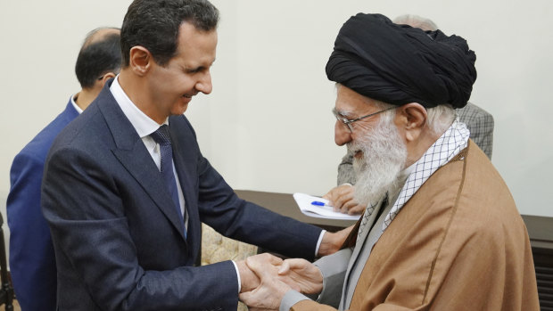 Syrian President Bashar Assad shakes hands with Iranian Supreme Leader Ayatollah Ali Khamenei before their meeting in Tehran on Monday.