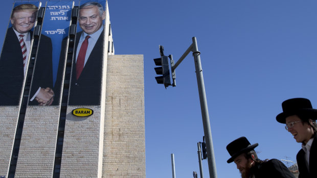 An election campaign billboard shows Israeli Prime Minister Benjamin Netanyahu, right, and US President Donald Trump in Jerusalem. Hebrew on the billboard reads: "Netanyahu is a different league." 