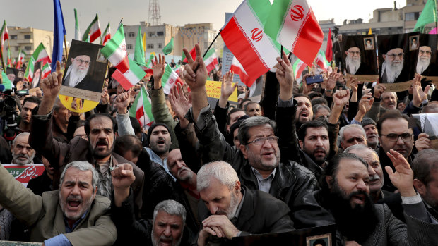 Demonstrators chant slogans during a pro-government rally denouncing the previous week's violent protests over a fuel price hike.