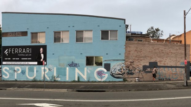 An old photo of the building covered in graffiti. 