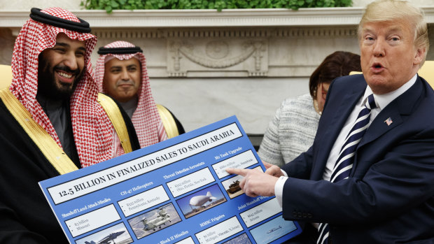 US President Donald Trump holds a chart highlighting arms sales to Saudi Arabia during a meeting with Saudi Crown Prince Mohammed bin Salman in the Oval Office in March.