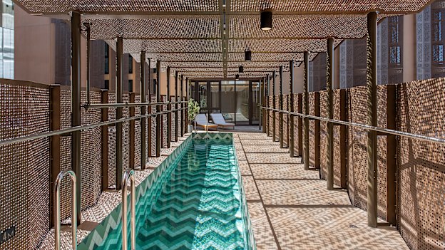 The Vibe’s pool, set on a suspended bridge one storey up, connects the hotel with an adjacent apartment building.