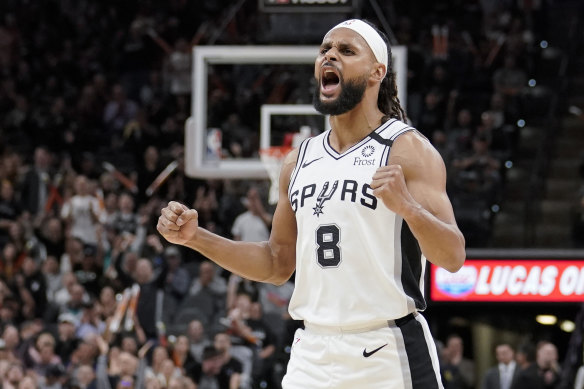 Patty Mills celebrates a basket against the Heat.