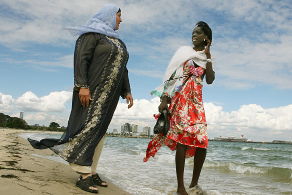 Nyuon (right) at Port Melbourne beach in 2007 promoting water safety for migrants.