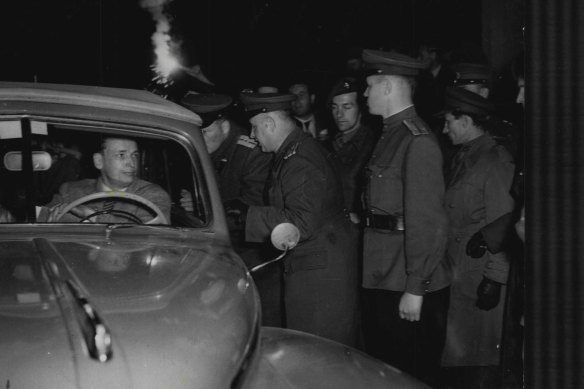 Russian officers check one of the first American cars to cross the border at Helmstedt after the blockade was lifted.