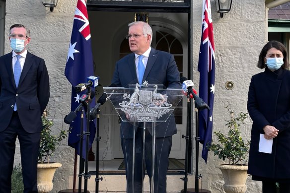 Prime Minister Scott Morrison, flanked by NSW Treasurer Dominic Perrottet and Premier Gladys Berejiklian.