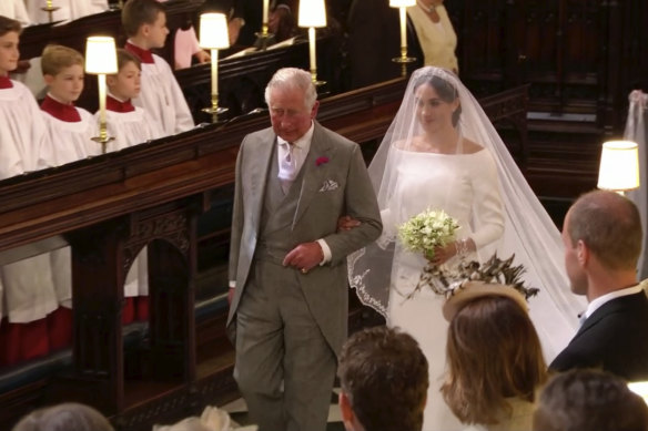 Meghan Markle walks down the aisle with Prince Charles for her wedding ceremony at St. George's Chapel in Windsor Castle in 2018.