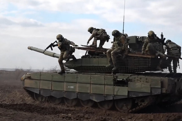 Russian servicemen jump off a T-90M Proryv tank during combat training, in a photo released by the Russian military.