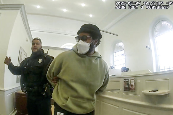 A police video still shows Coogler being led out of the bank in handcuffs. 