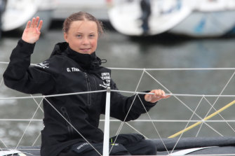 Greta Thunberg waves to her supporters on her arrival in New York aboard the zero-emissions yacht Malizia II.