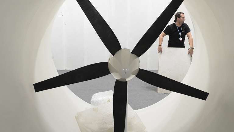 A worker dismantles the exhibition pavilion of Austria after the UN Climate conference ended, but negotiators from almost 200 countries continued haggling over the fine print of the Paris climate accord in Katowice, Poland, Saturday.