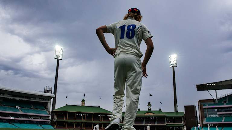 Under the weather: Jack Edwards of the Blues fields as storm clouds come in on Wednesday.