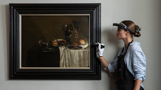 Senior paintings conservator Claire Heasman inspects the painting, confirmed to be a Dutch Master from the 17th century during restoration.