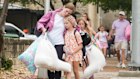 A woman and a child embrace after girls from Camp Waldemar, near the North fork of the Guadalupe River, are reunited with their families after heavy rainfall in Central Texas. 