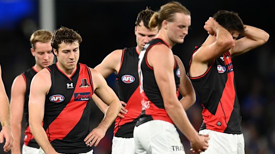 Essendon players after their loss to the Bulldogs.