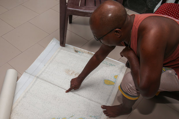 Fernando outlines the route towards Australia on a nautical chart.