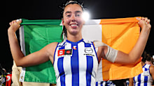 Blaithin Bogue of the Kangaroos poses with an Irish flag after winning the AFLW Grand Final.