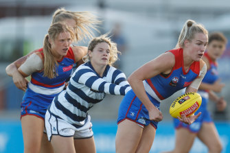 The Bulldogs’ Celine Moody is tackled by Georgie Prespakis of the Cats.