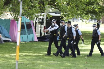 Police at the perimeter of the protest camp site between Old Parliament House and the National Portrait Gallery in Canberra on Friday.