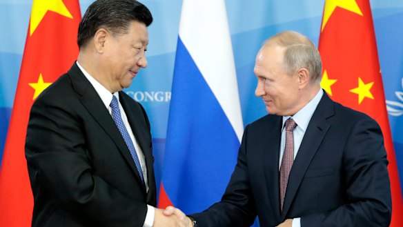 Russian President Vladimir Putin, right, shakes hands with Chinese President Xi Jinping after their news conference at the Eastern Economic Forum in Vladivostok, Russia, 