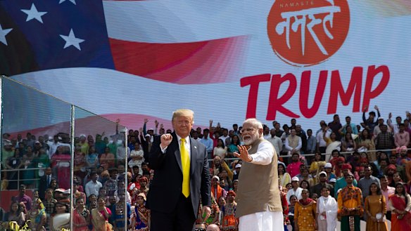 US President Donald Trump and Indian Prime Minister Narendra Modi wave after a "Namaste Trump" event at Sardar Patel Gujarat Stadium.