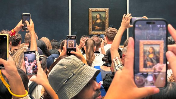 Tourists jostle to photograph Leonardo da Vinci’s The Mona Lisa at the Louvre Museum in Paris, France, in August 2024.