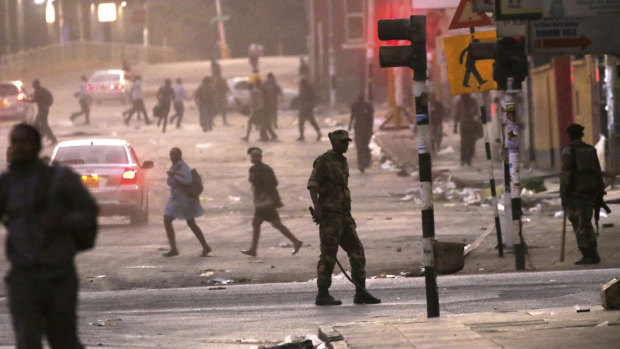 Hundreds of angry opposition supporters outside Zimbabwe's electoral commission were met by riot police firing tear gas as the country awaited the results of Monday's presidential election, the first after the fall of longtime leader Robert Mugabe. 