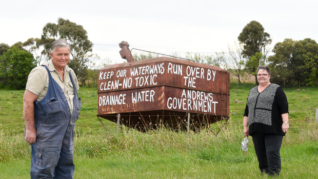 John McKenzie and sister Heather Dodd in front of protest signs against the dumping of toxic soil from the Metro Tunnel opposite their property in Bulla.