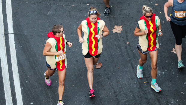 Three women ran the SMH Half Marathon in hot dog suits.
