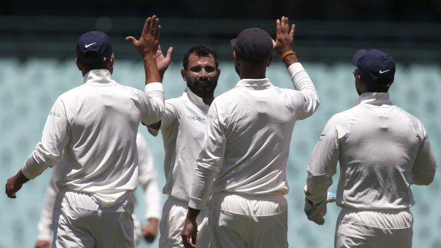 High five: Mohammed Shami, second left, celebrates after taking a wicket in the tour match in Sydney.