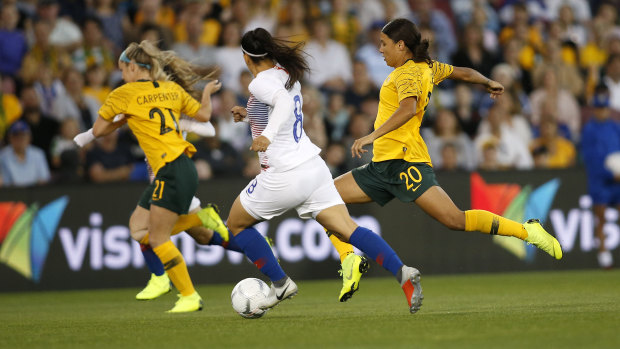 Sam Kerr of the Matildas (right) controls the ball during a friendly match against Chile in Newcastle last November.
