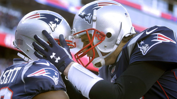 Patriots quarterback Tom Brady (right) celebrates his touchdown pass to wide receiver Phillip Dorsett.
