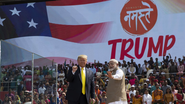 Donald Trump and Narendra Modi wave after a "Namaste Trump" event at Sardar Patel Gujarat Stadium.